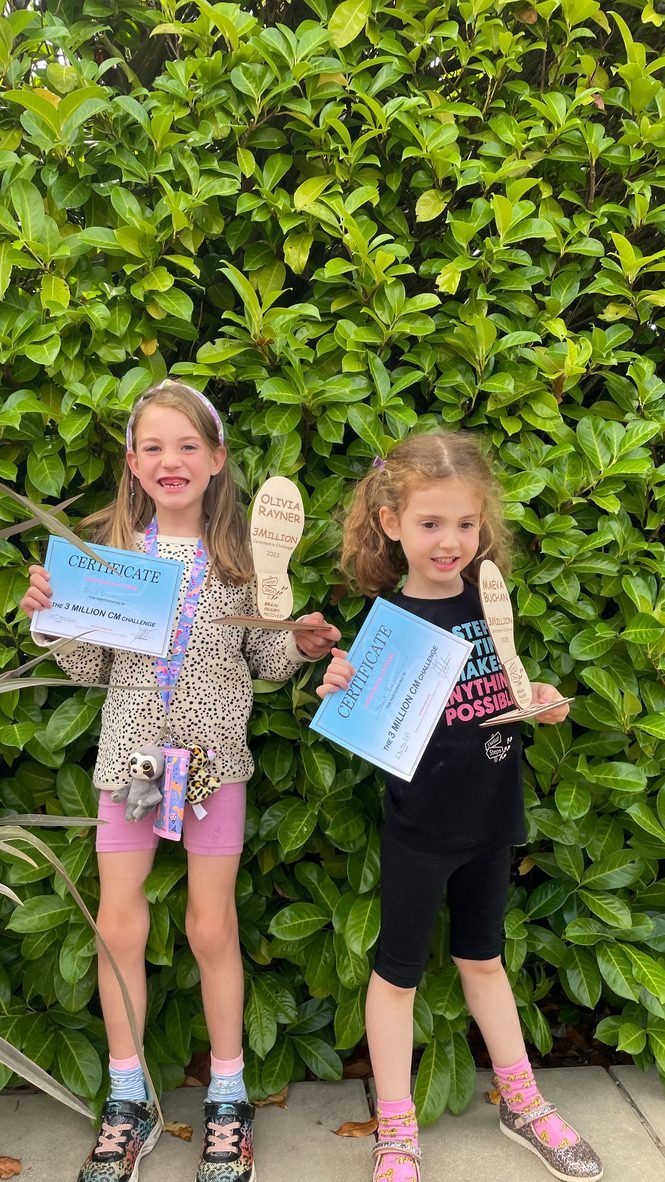 Two young fundraisers with their certificates and footprint awards